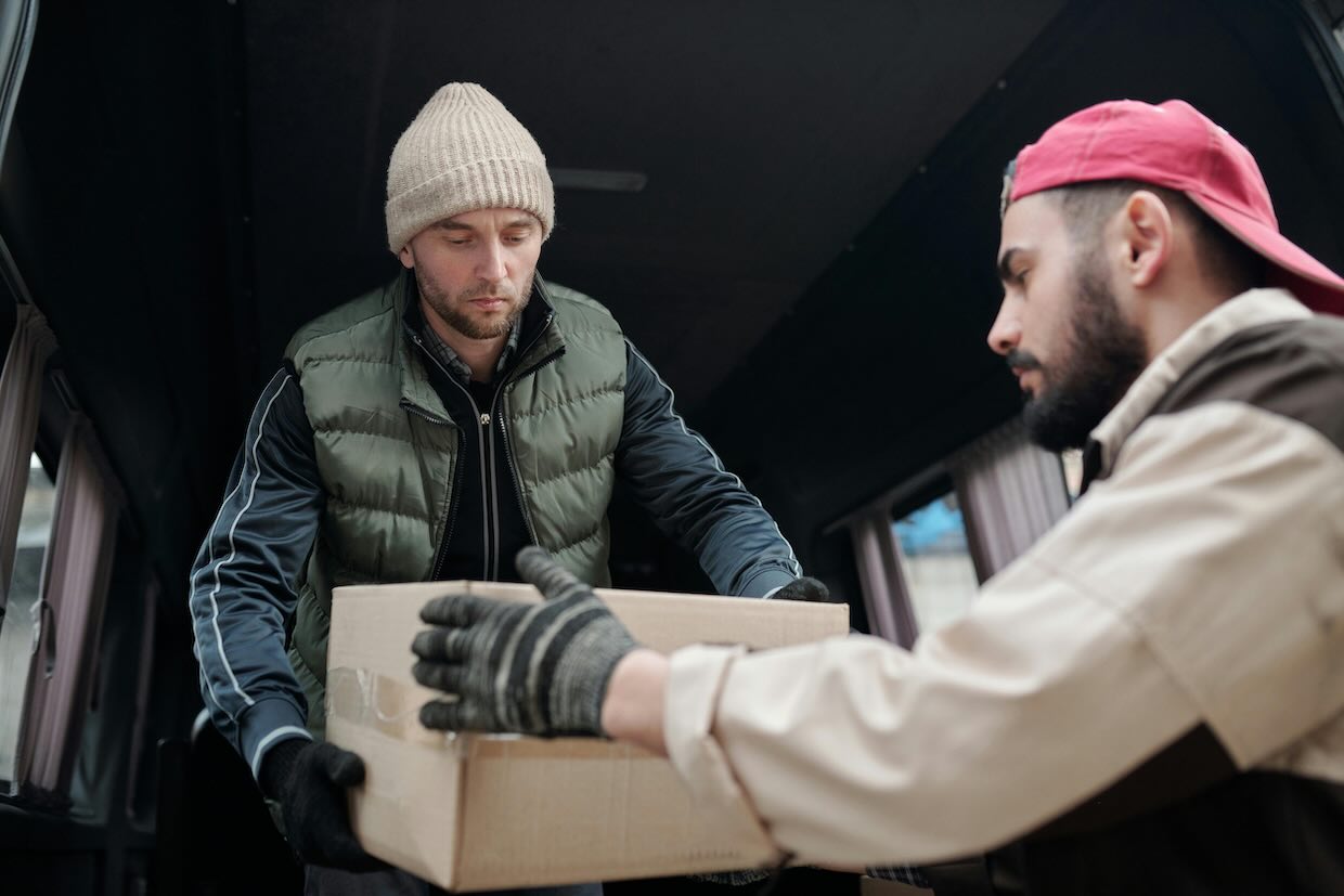 Men holding a cardboard box