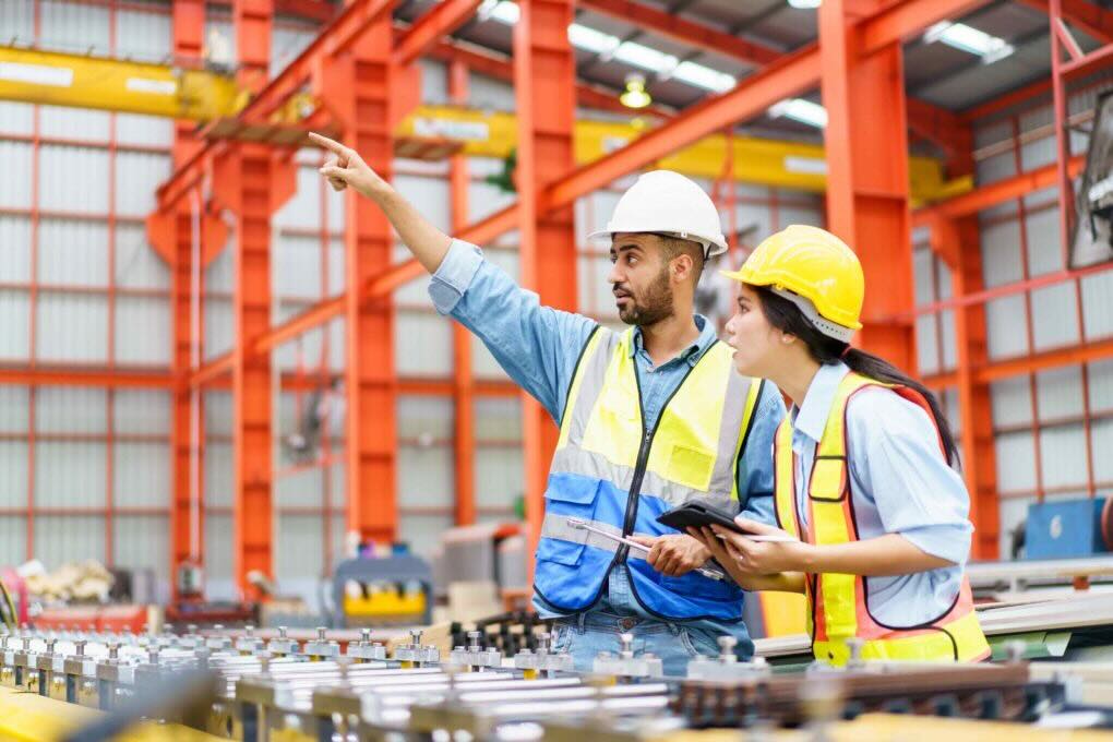 Two engineers pointing at something & discussing